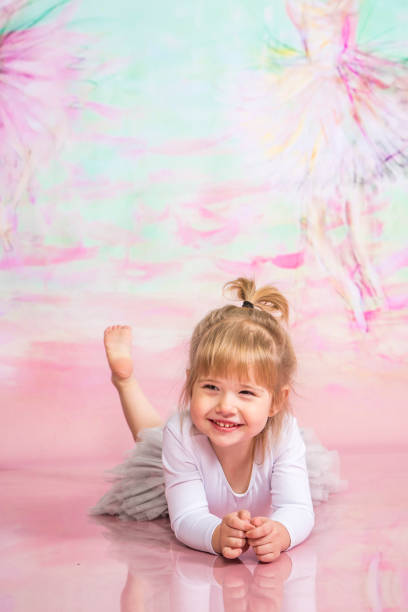 istock Cute Little Ballerina Doing Exercises Set in the studio 1983163919