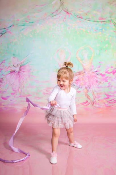 istock Cute Little Ballerina Doing Exercises Set in the studio 1983164955