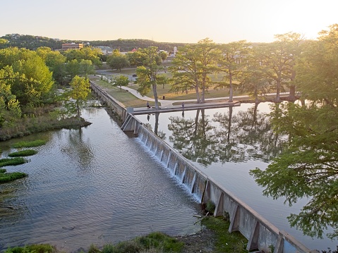 Guadalupe river flows over weir in downtown Kerrville Texas. Scenic beauty in the Texas hill country.