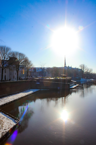 Den Bosch, the Netherlands / January 2024: View on the Dommel river from Wilhelminabrug in 's-Hertogenbosch on a very rare snowy day.