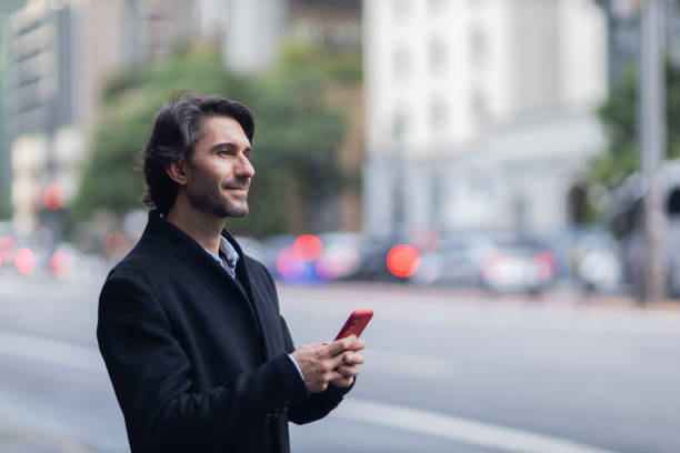istock View of young man using a smartphone at twilight 1983263977