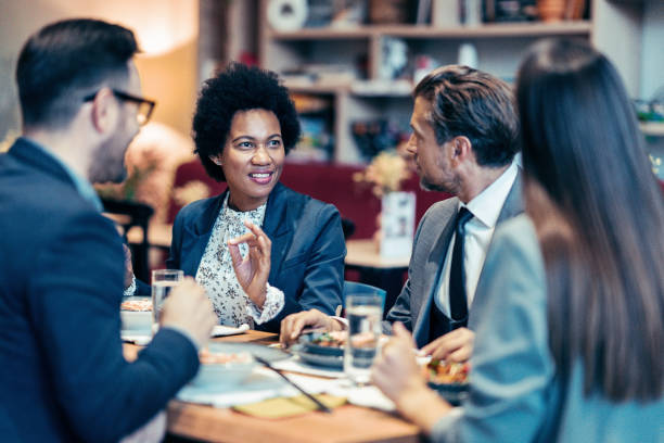 istock Businesswoman talking during corporate dinner 1983271681