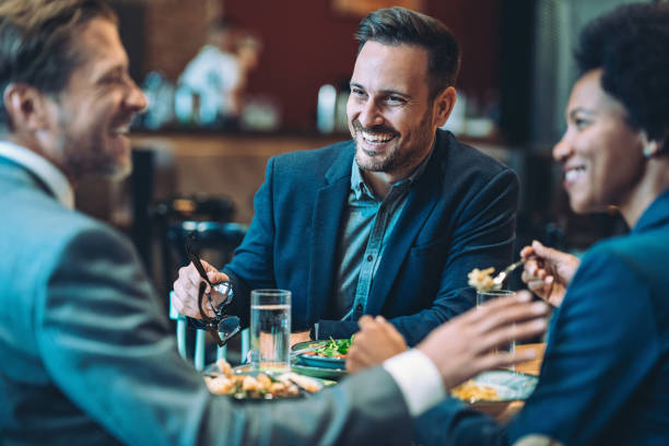 istock Focus on a smiling businessman during business dinner 1983271684