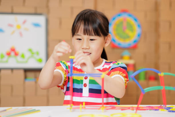 istock young girl playing Construction toys at home 1983291915