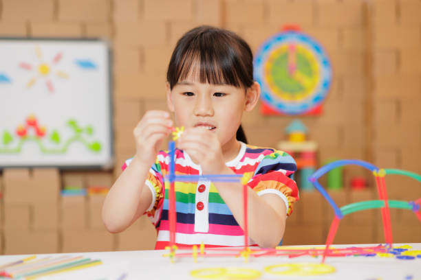 istock young girl playing Construction toys at home 1983291916