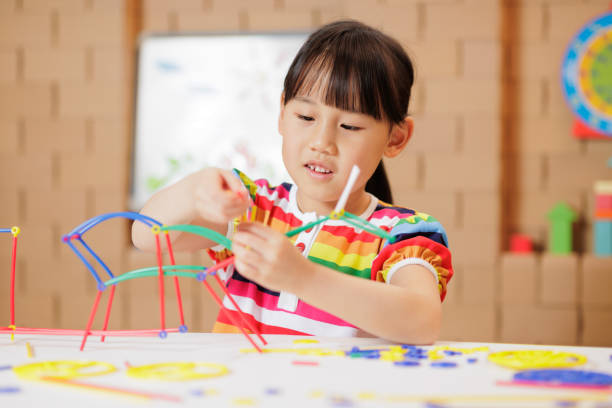 istock young girl playing Construction toys at home 1983291925
