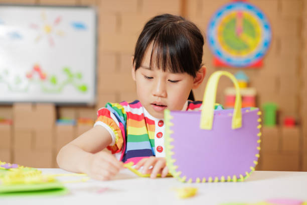 istock young girl making craft at home 1983292432