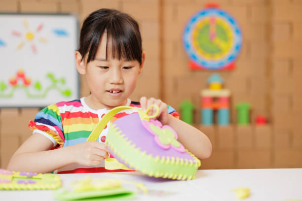 istock young girl making craft at home 1983292438