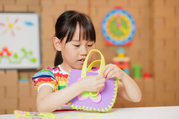 istock young girl making craft at home 1983292442