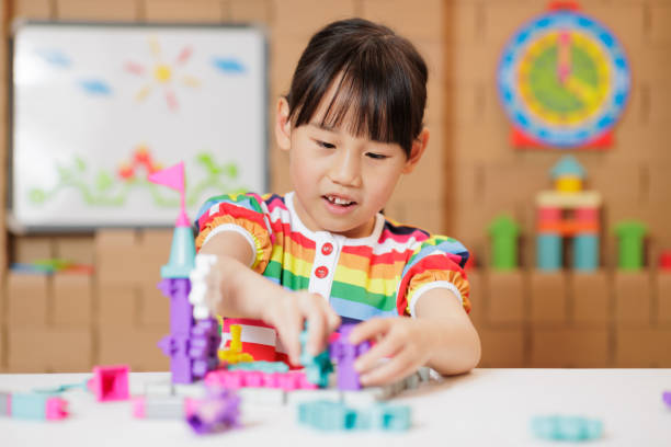 istock young girl playing Construction toys at home 1983292444