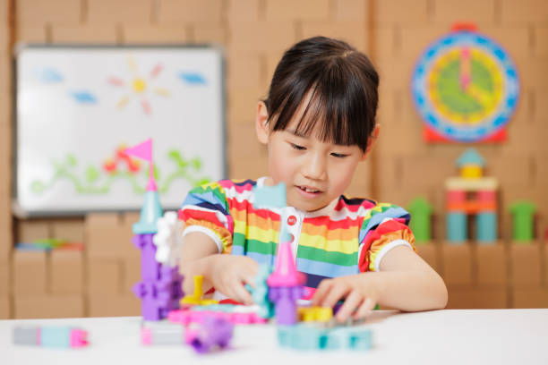 istock young girl playing Construction toys at home 1983292445