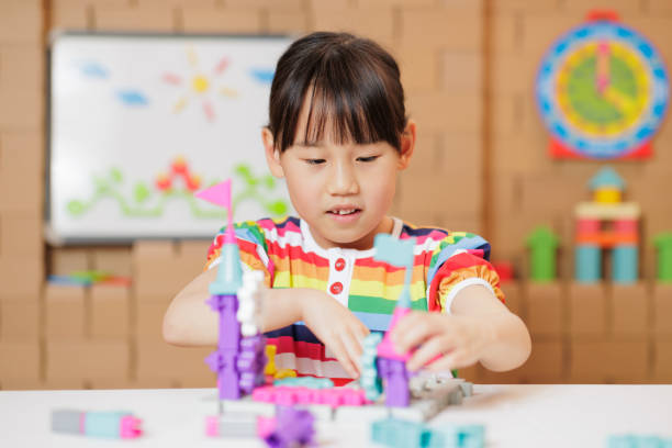 istock young girl playing Construction toys at home 1983292449