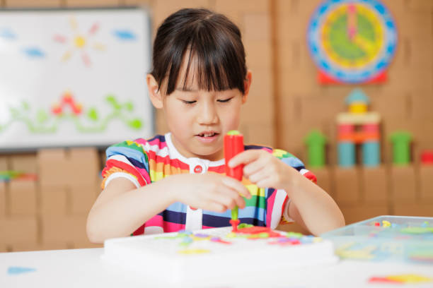 istock young girl playing Construction toys at home 1983292452