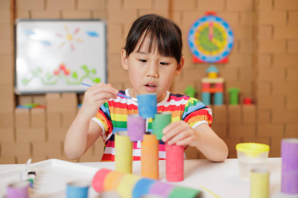 istock young girl making craft at home 1983293471