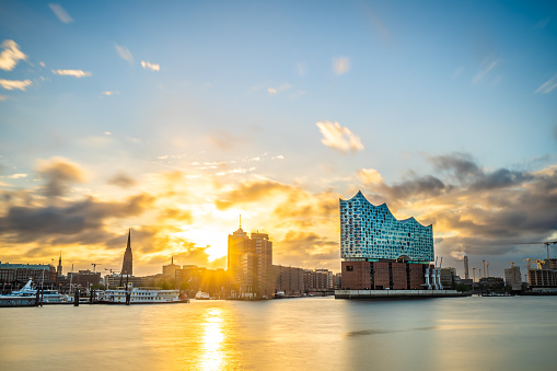 Golden sunrise in Hamburg next to the characteristic landmark Elbphilharmonie.