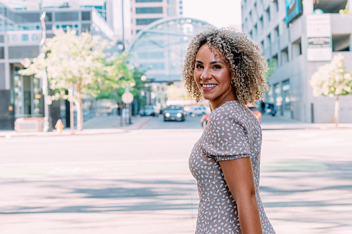 Young African-American Woman Looking Over Her Shoulder at Camera, Downtown Salt Lake City, Utah with Copy Space