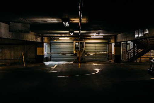 Dark Parking Garage Entrance & Exit Booth in an Eerie Parking Garage in the Late Afternoon