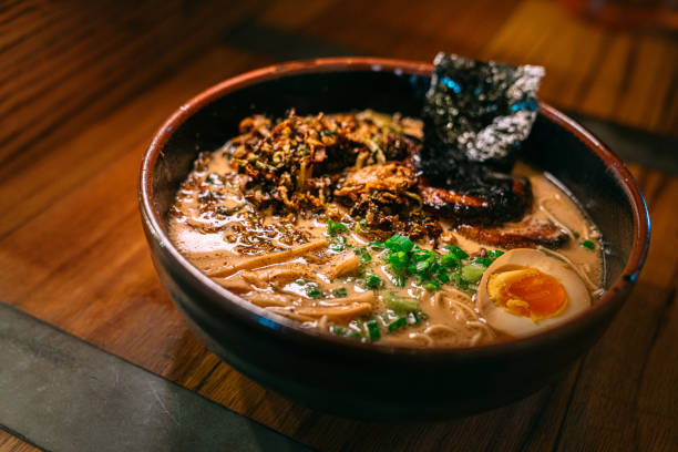 istock Savory Tonkotsu Ramen in a Bowl on a Wooden Table under 1983335210