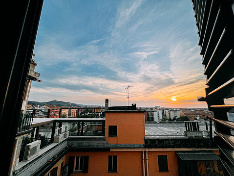 Sunset View from an Apartment Shutter Window in Bologna, Italy in the Summer