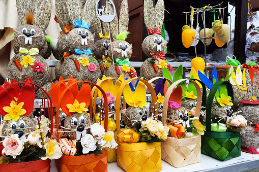 Festive stalls showcase with Easter baskets and bunnies. Crafted bunnies made from straw, branches, and natural materials. Seasonal gifts and Handcrafted items.
