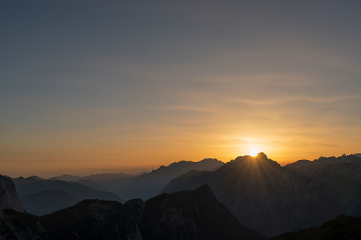 Mountain range of Julian Alps at sunset. The closest are Mangart, Kanin.