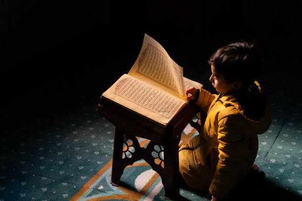 Bursa,Turkey - October 19, 2014: Young man studying Koran in a historic Ottoman mosque on the uphills of Bursa