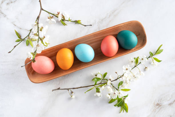 istock Easter chicken multicolored eggs in a clay plate are on the table 1983378550