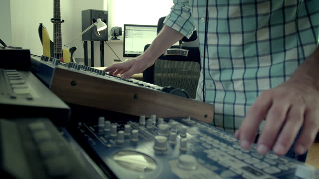 Making music. Man turning knobs of an audio mixer