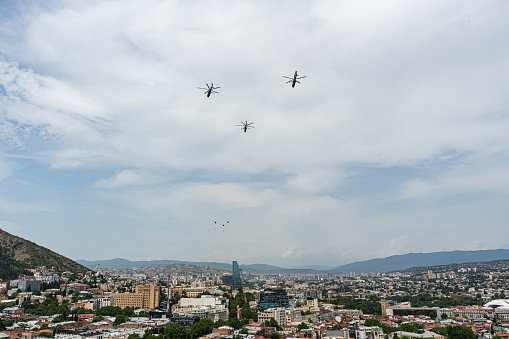 Helicopters with Georgian flags fly in the sky of Tbilisi city on the Independence Day of Georgia 26th if May 2023