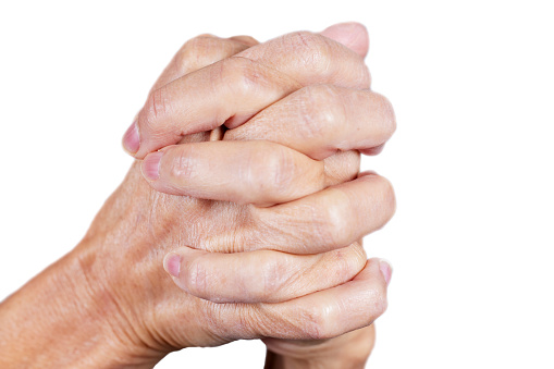 Close up of mature female hands in a clasped position