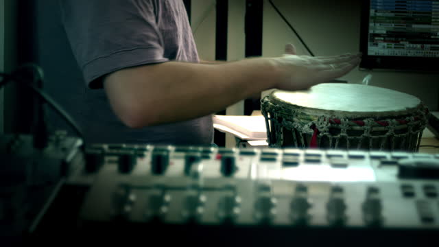 Making music. Man playing on a drum