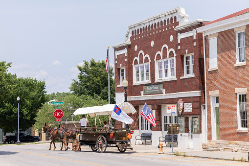 Independence, Missouri, USA - June 16, 2023: Visitors take a guided tour via horse carriage of the Harry S Truman National Historic Site in downtown Independence.