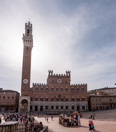 Siena, Italy - September 11, 2023 - The iconic Palazzo Pubblico at the Piazza del Campo in downtown Siena, Italy