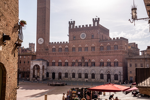 Siena, Italy - September 11, 2023 - The iconic Palazzo Pubblico at the Piazza del Campo in downtown Siena, Italy