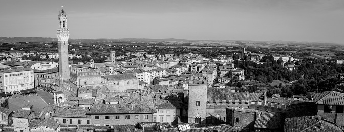 Siena, Italy - September 11, 2023 - View over the roofs of Siena towards the Torre Magna, seen from the roof of the Siena cathedral, Italy