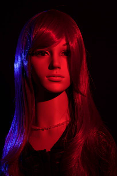 Mannequins stand side by side wearing colorful winter hats and scarves in a clothing store. The display highlights cozy fashion options perfect for cold weather.
