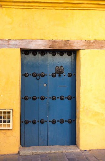 Oaxaca, Mexico: Sunlit Wood Door in Vibrant Wall