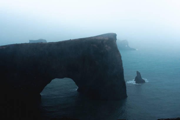 Dyrholaey Cape, moody view under fog and rain, Iceland
