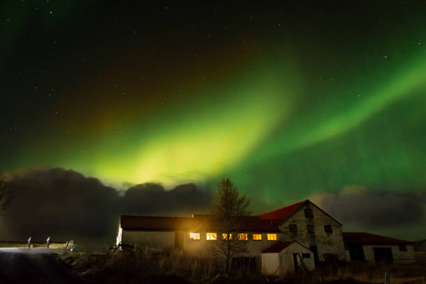 istock Northern Light,  spectacular Aurora borealis over a farm in Iceland 1983505021