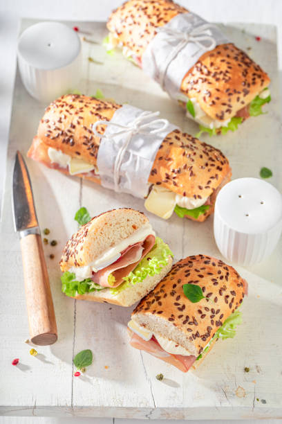istock Fresh sandwich with camembert, prosciutto and mayonnaise. 1983516716
