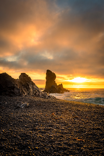 Sunset over the volcanic lava formations of Djupalonssandur beach, Iceland