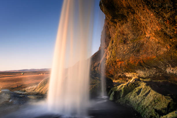 istock Amazing view from behind the Seljalandsfoss Waterfall at sunset,  Iceland 1983527696