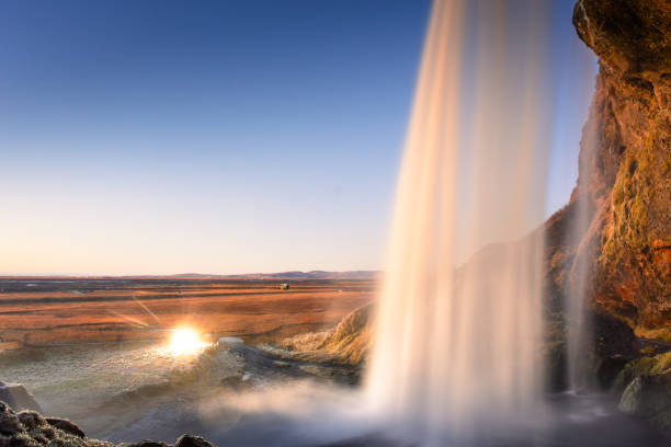 istock Amazing view from behind the Seljalandsfoss Waterfall at sunset,  Iceland 1983527697