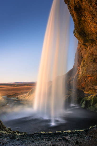 istock Amazing view from behind the Seljalandsfoss Waterfall at sunset,  Iceland 1983532875