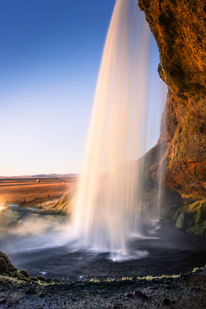 Amazing view from behind the Seljalandsfoss Waterfall at sunset,  Iceland
