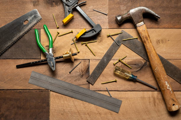 istock Hand tools on a rough wood plank background 1983537062