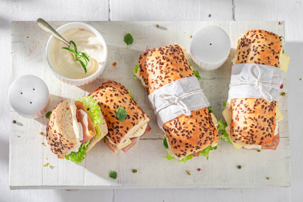 istock Delicious sandwich with prosciutto, camembert and lettuce. 1983537569