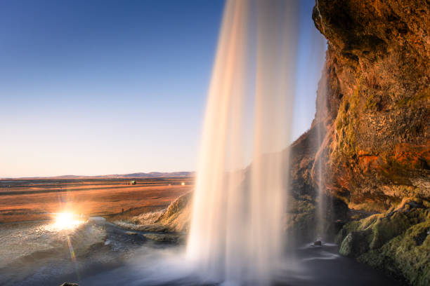 istock Amazing view from behind the Seljalandsfoss Waterfall at sunset,  Iceland 1983539139