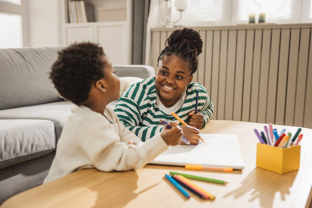 istock Mother and son coloring together 1983602846