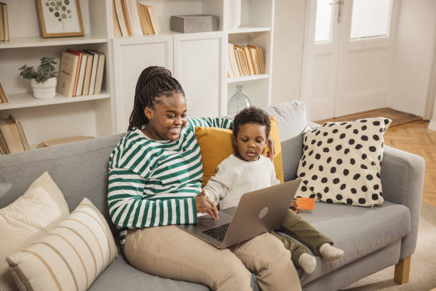 istock Mother and baby boy using laptop 1983606524